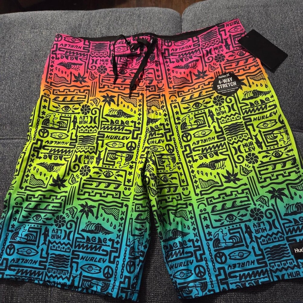 Hurley boys board shorts with black line art featuring eyes, palm trees, and tex